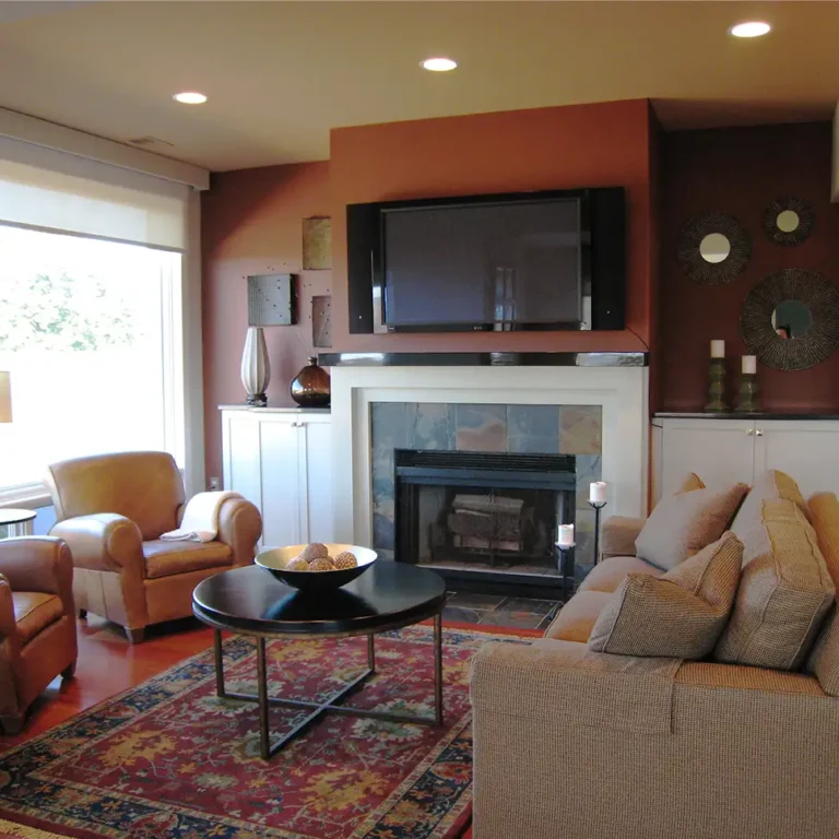 Renovated living room showing fireplace, rug, new furniture