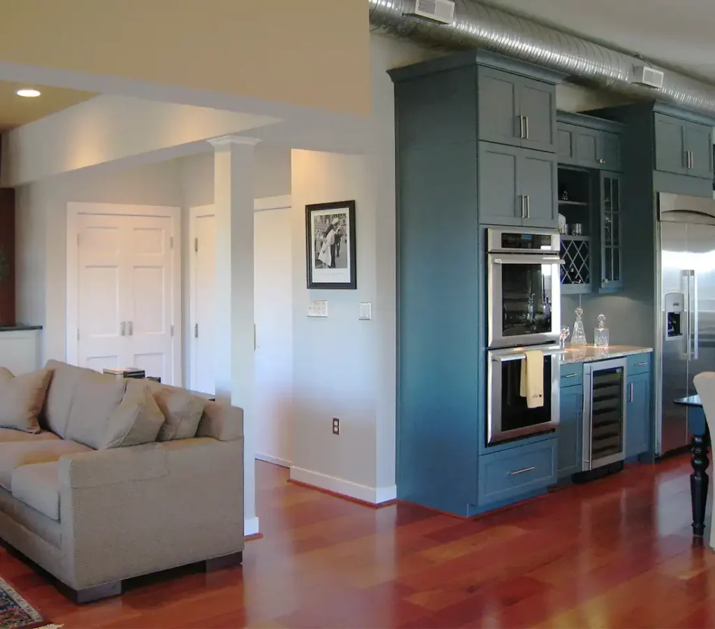 After image showing wall removal, kitchen cabinetry and new flooring