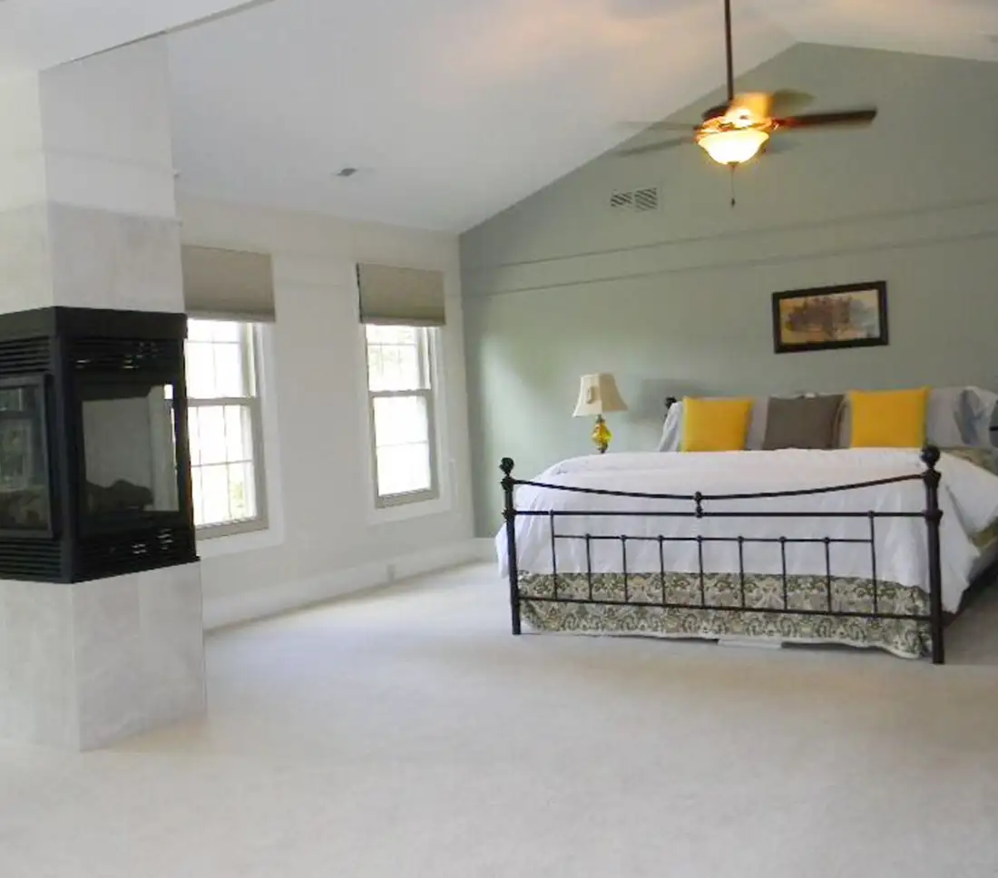 Bedroom after staging, showing updated fireplace
